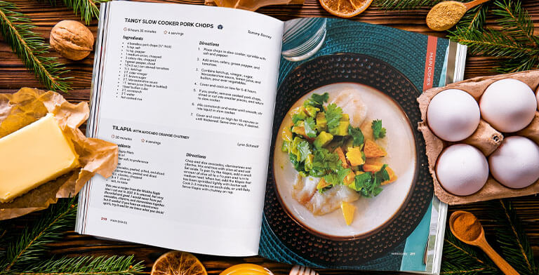 a cookbook on a holiday decorated table