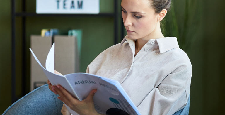 OnPress employee handbook printing woman reading professionally printed handbook