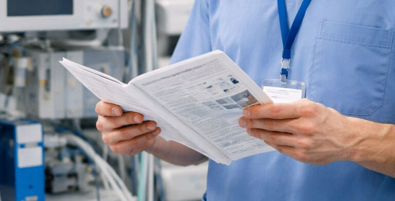 A technician reading a medical equipment manual