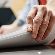 Hands handling printed book pages
