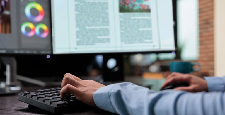 OnPress prepress production designer reviewing book layout files